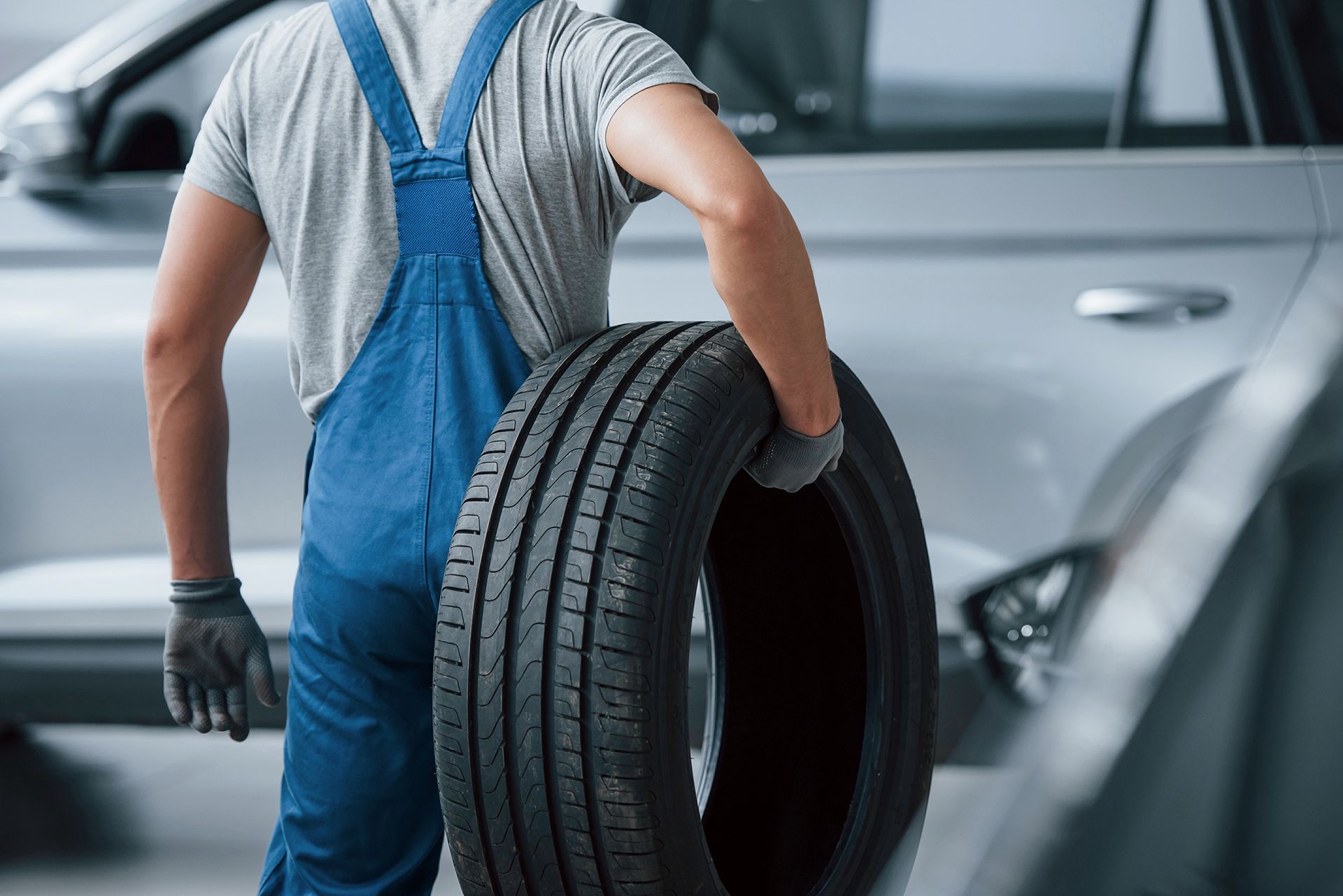 mechanic holding a tire at the repair garage
