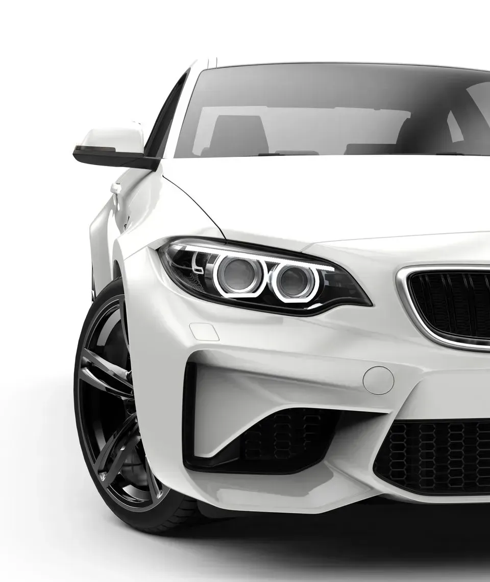 Front view of a white sports sedan with black wheels on a white background