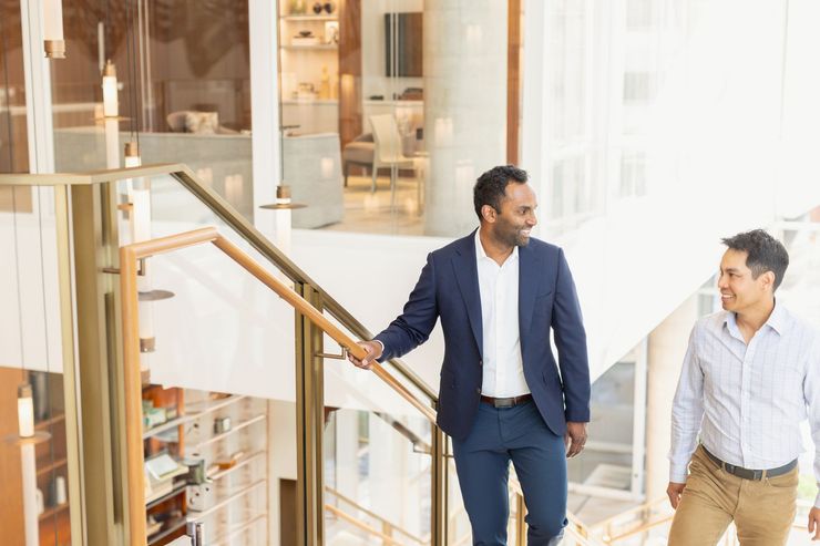 DMP Technologies President Menaka walking up the stairs with colleague