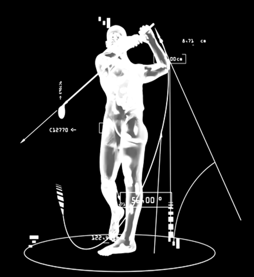 A man is swinging a golf club in front of a large screen.