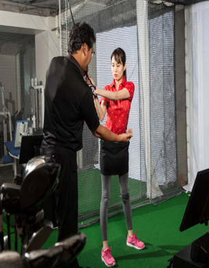 A man standing next to a golf bag that says jon smith