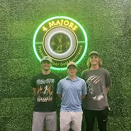 Three men standing in front of a sign that says 4 majors