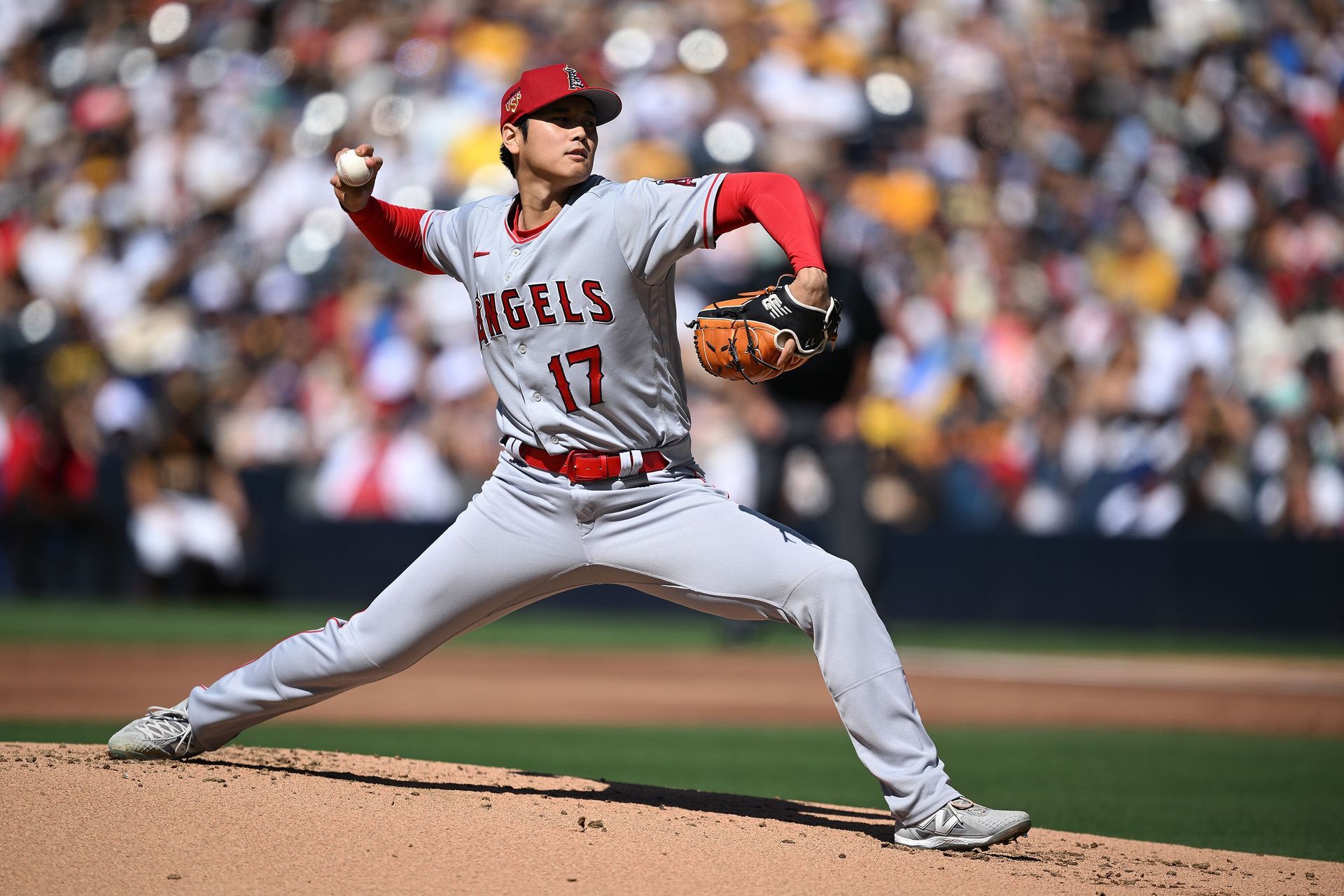 A baseball player is pitching a ball on a baseball field.