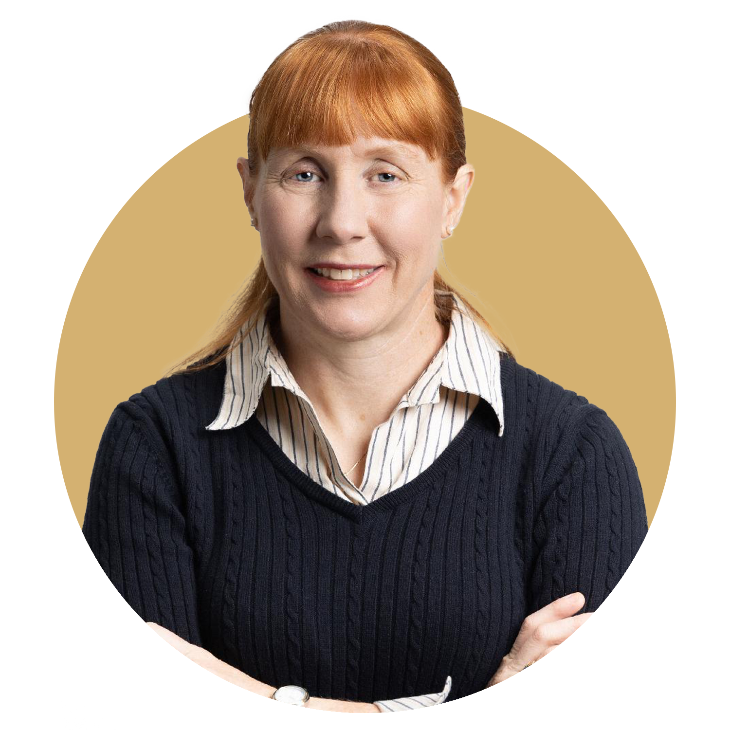 A woman with red hair is wearing a green jacket and a necklace.