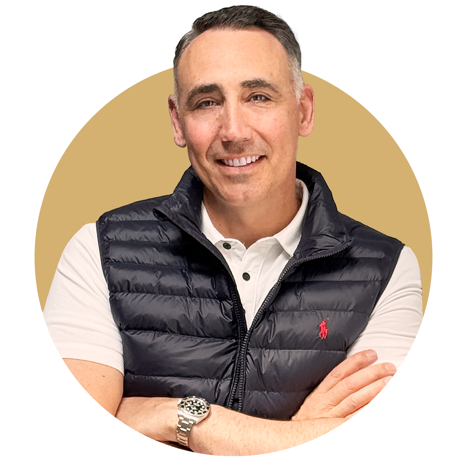 A man in a suit is leaning against a brick wall with his hands in his pockets.