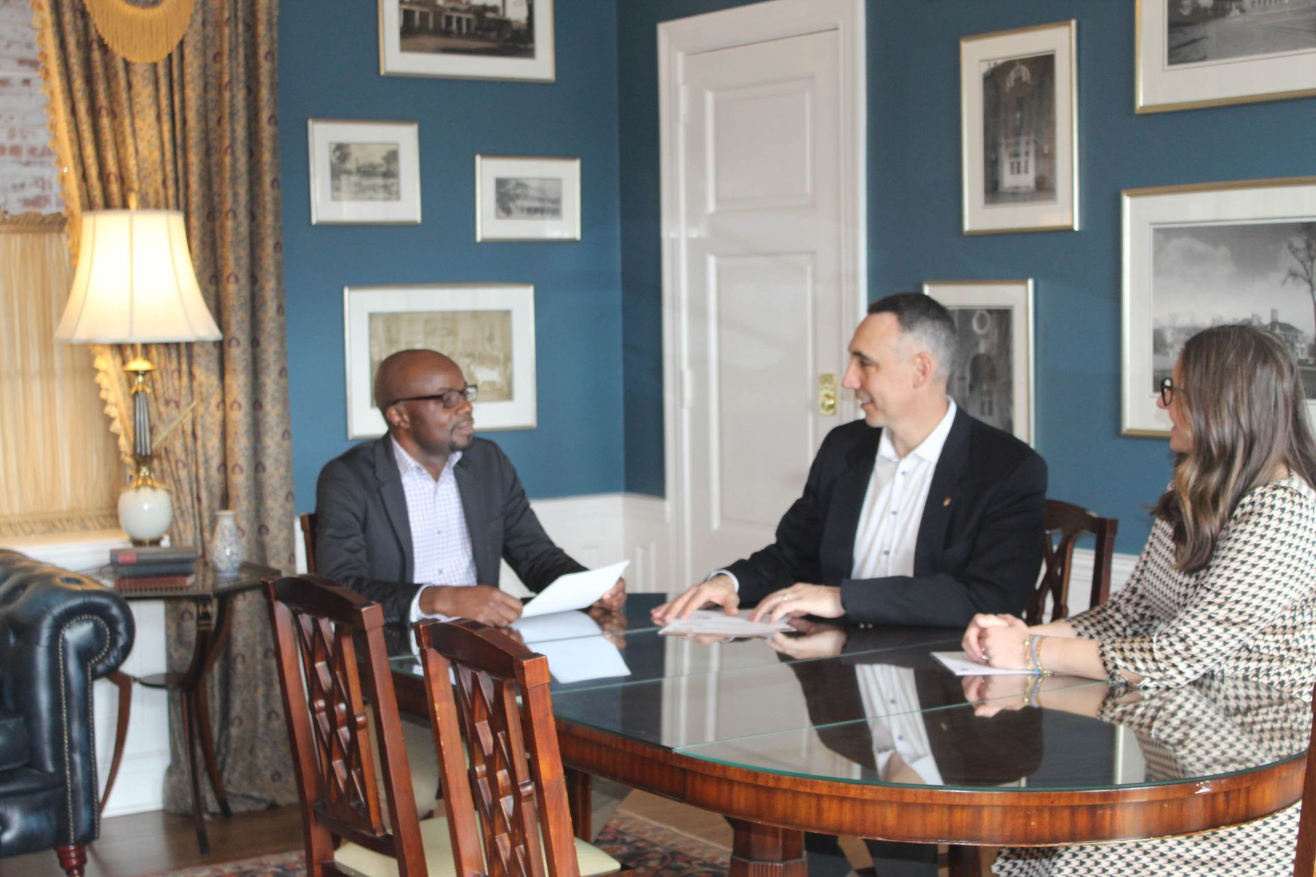 A group of people are sitting around a table in a room.