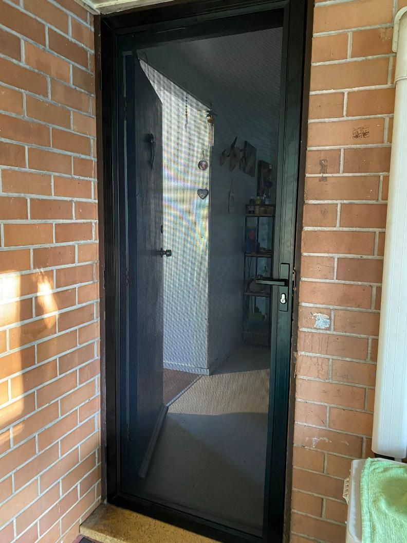 A Black Screen Door Is Sitting on A Brick Wall — Midges No More in Taree, NSW