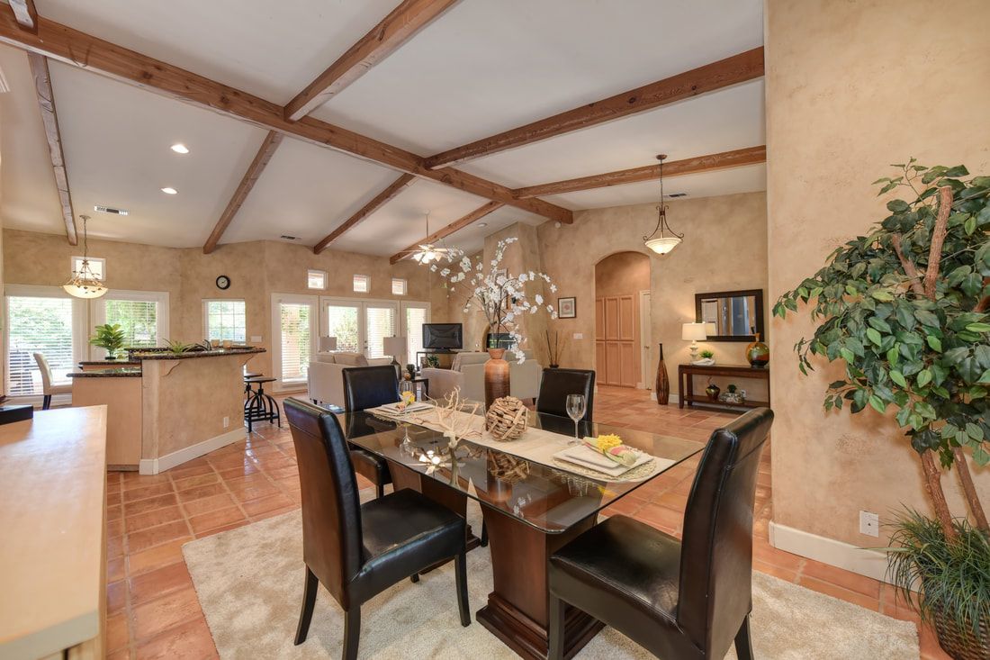 A dining room with a table and chairs in it