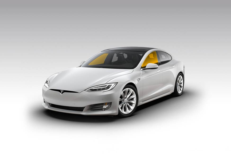 White Tesla Model S electric car on a white background, yellow tinted windows.