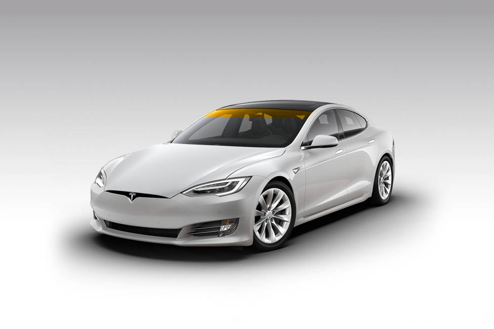 White Tesla Model S on a gradient gray background. Golden sunlight shines through the windshield.