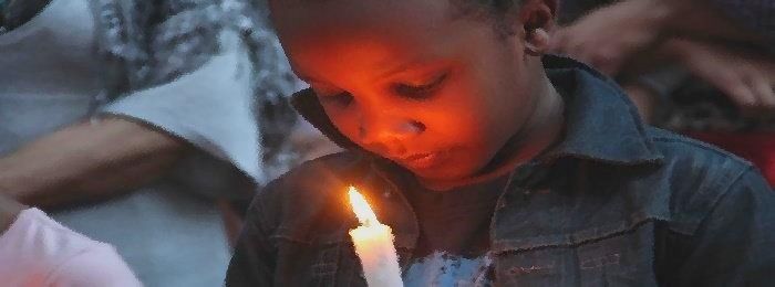 young boy with candle
