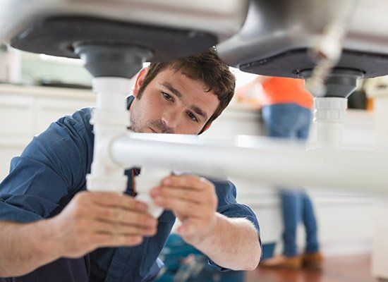 Man Fixing Pipes — Hartford, CT — Macca Plumbing & Heating