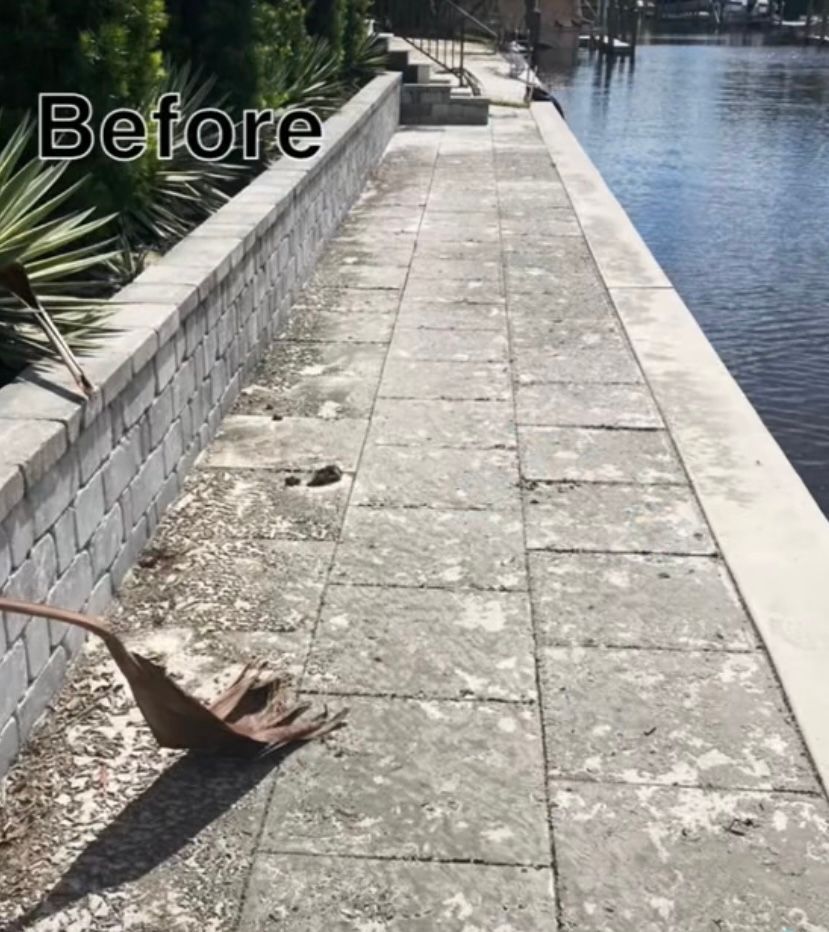 A before picture of a walkway next to a body of water