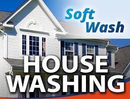 A white house with the words `` soft wash house washing '' written on it.