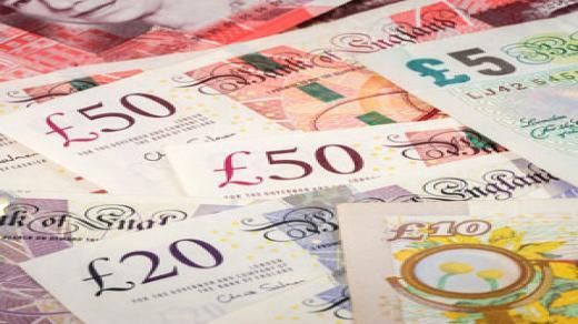 Pile of British banknotes, including £50, £20, £10, and £5.