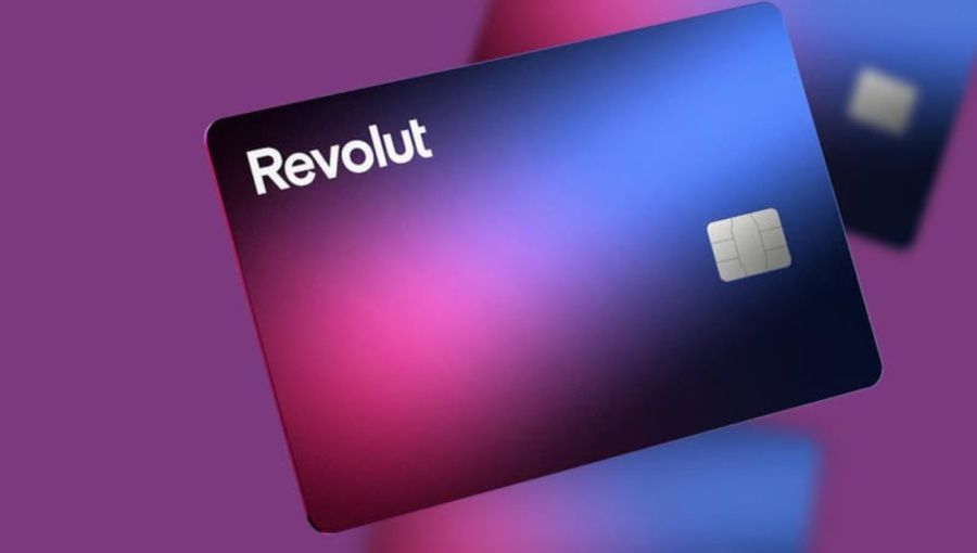 Revolut debit cards in a gradient of pink and blue, floating against a purple background.