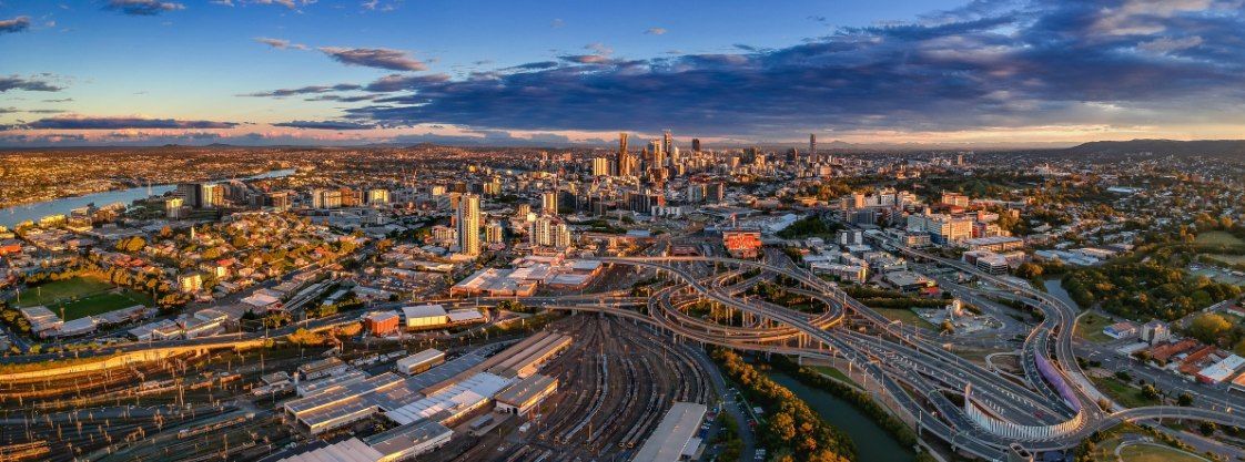 Aerial View of a Cityscape at Dusk With a River and Buildings — Delicious Entertainment In Bowen, QLD