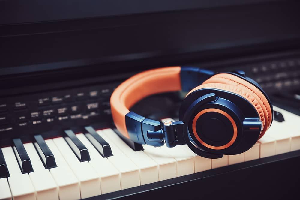Piano instructor Virginia Beach, VA: A pair of headphones sitting on top of a piano keyboard.