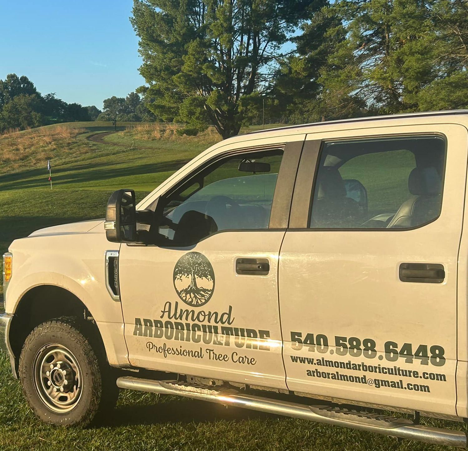 A white truck with the word almond on the side