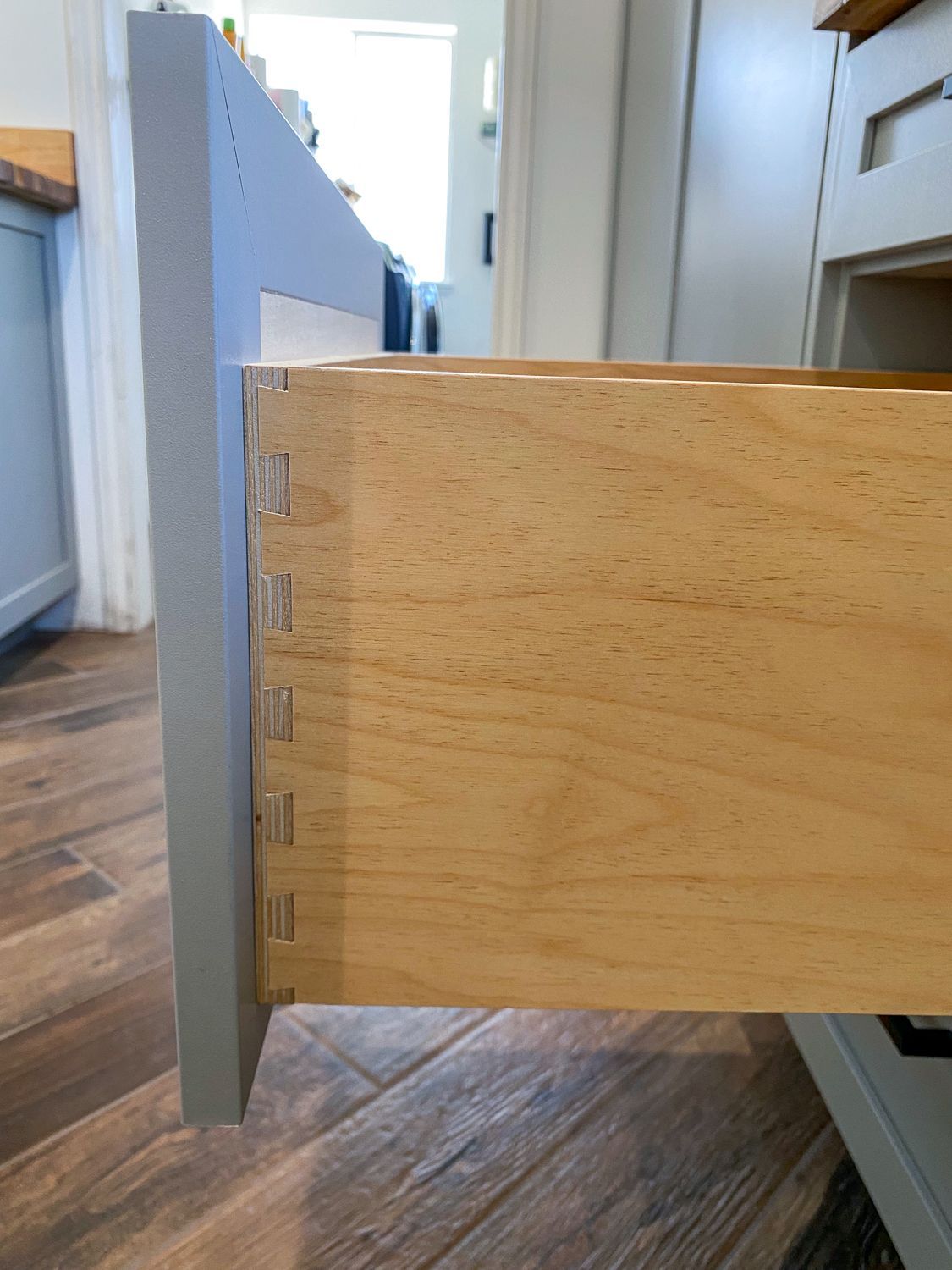 Open wooden drawer with dovetail joints.
