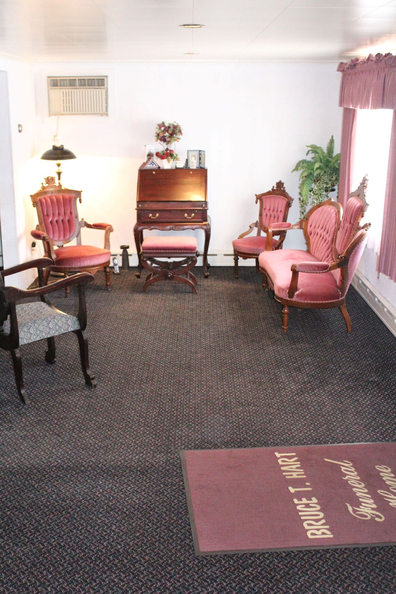 A living room with a rug that says bruce l hart