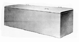 A black and white photo of a concrete box with a lid.