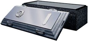 A black coffin with the lid open and a stainless steel door.