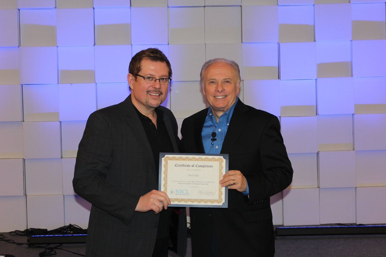 Dr. Mark Rutland standing next to a graduate holding a certificate