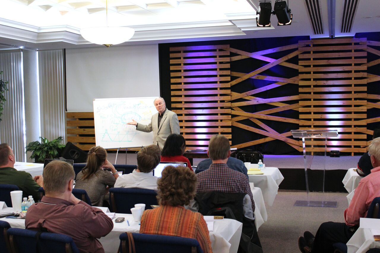 A man is giving a presentation to a group of people