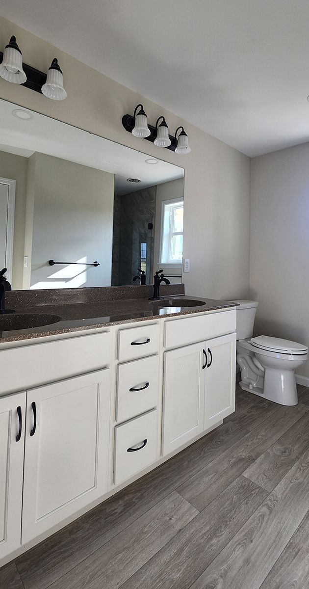 master bathroom with double sink and toilet
