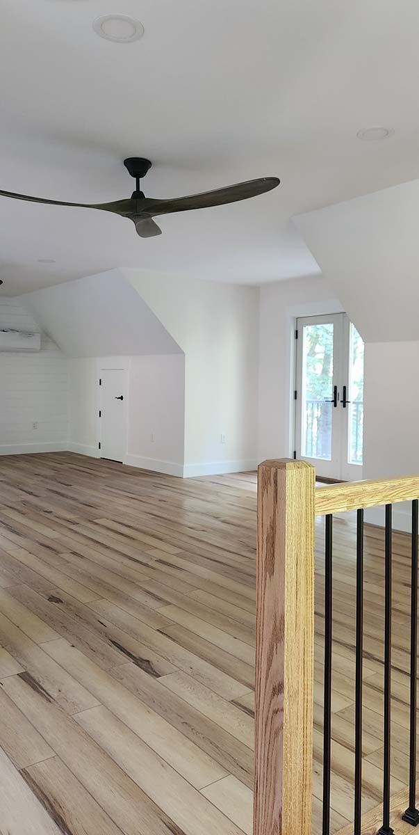 There is a ceiling fan in the corner of the room.