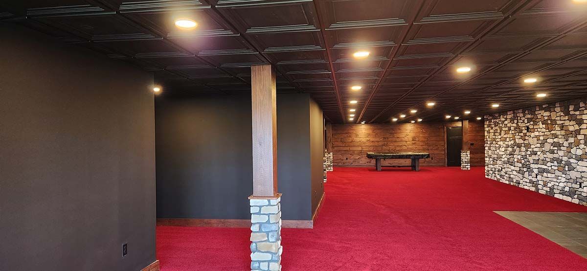 black walls, with stone covering around post and red carpet