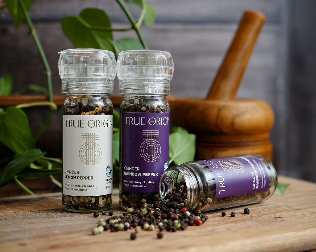 Two grinder, a white one containing Lemon Pepper and another containing Rainbow Peppercorns