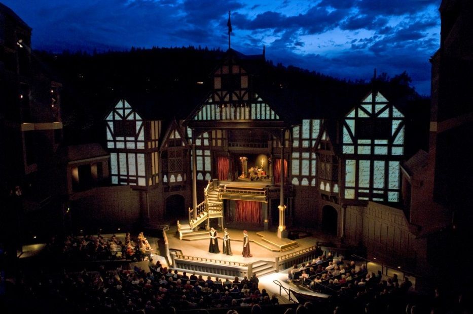 An aerial view of a stage with actors on it at night