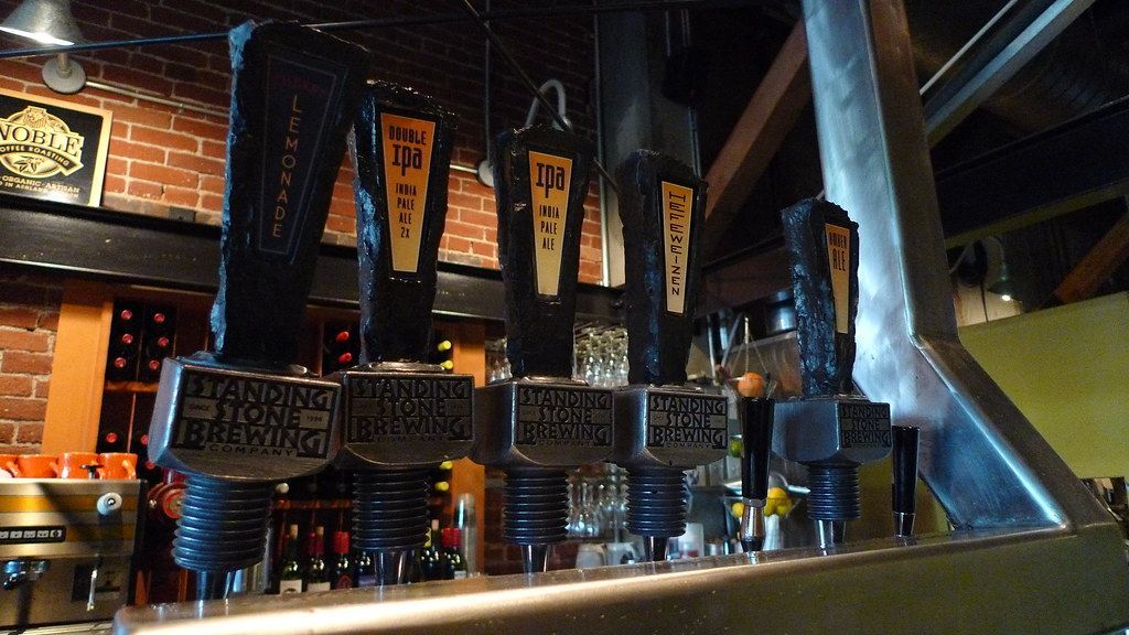A row of beer taps with one that says ' brewdog ' on it