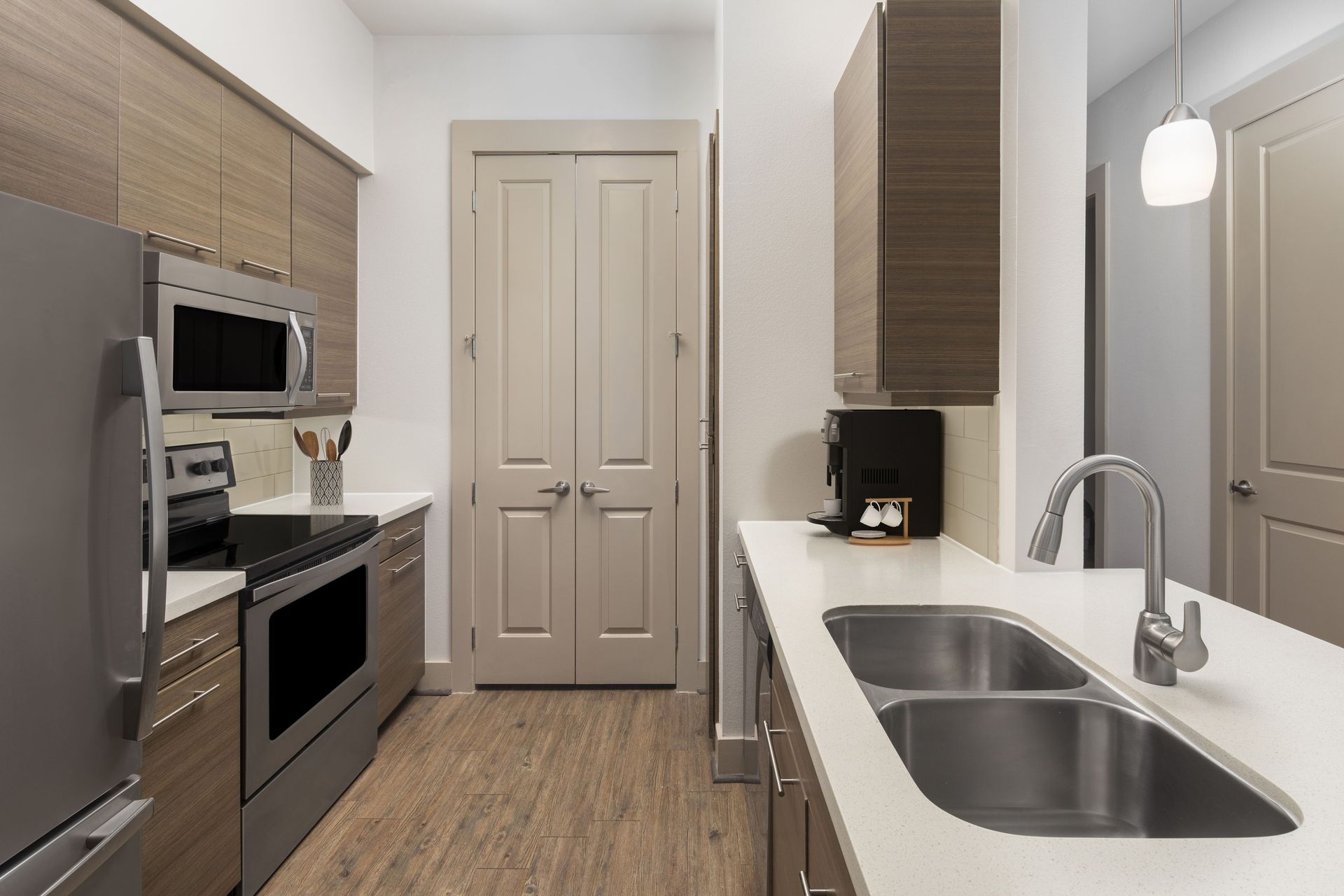Modern kitchen with stainless steel appliances and wooden cabinetry.