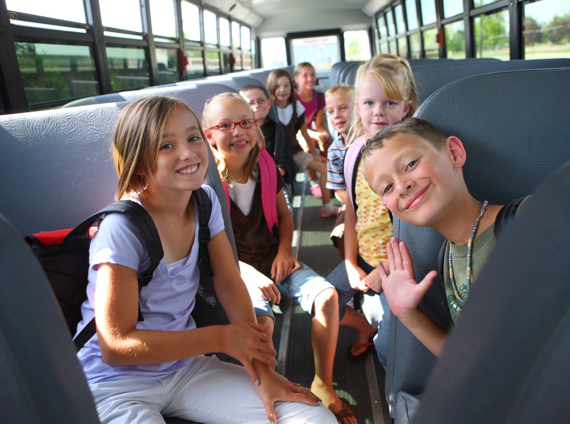 A group of children are sitting on a school bus.