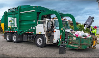 Green dump truck on a road. Green dump truck on a road.