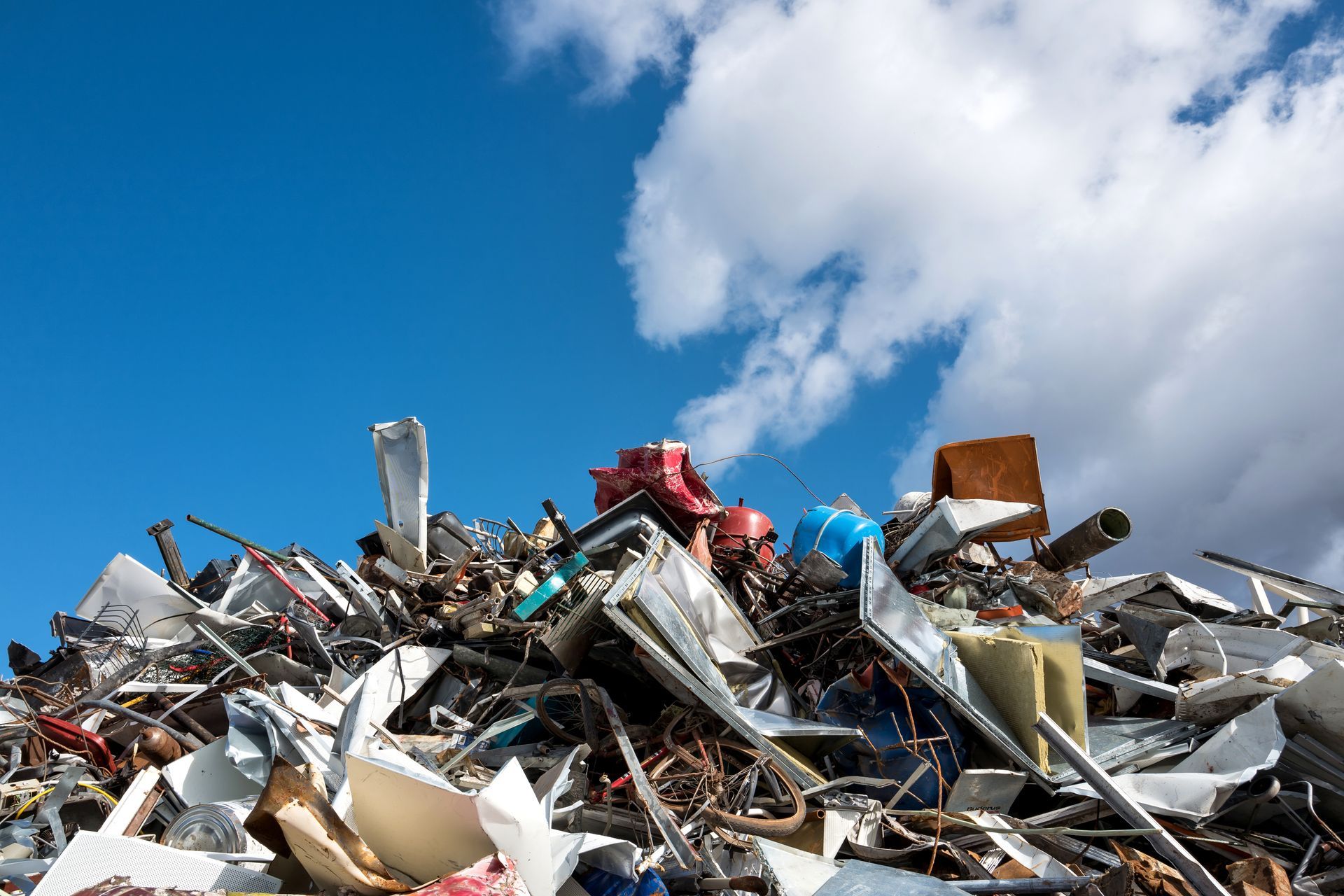 Pile of assorted scrap at a metal recycling center for sustainable resource recovery. Pile of assorted scrap at a metal recycling center for sustainable resource recovery.