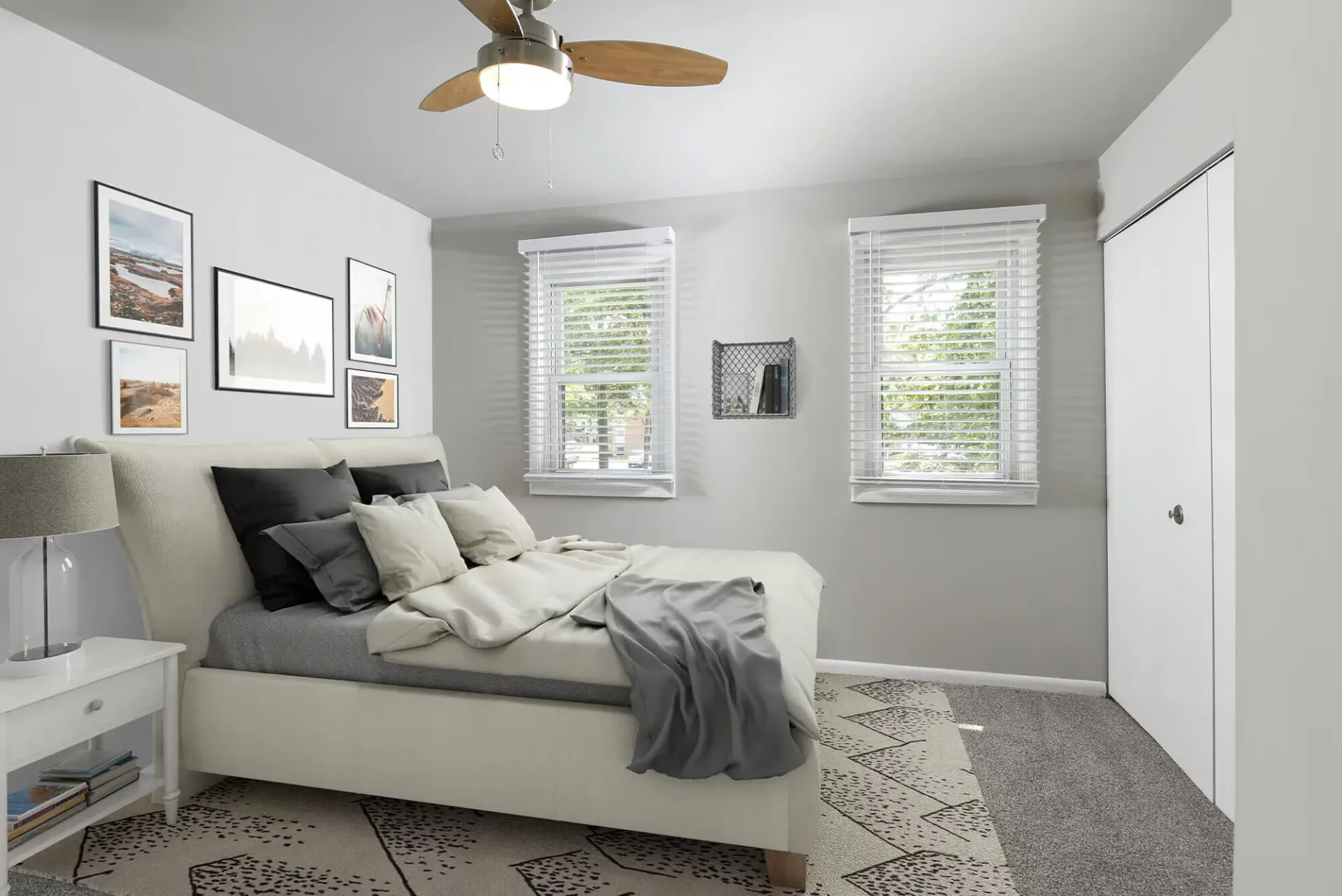 Bedroom with a neutral palette, a bed, two windows with white blinds, and a white closet.