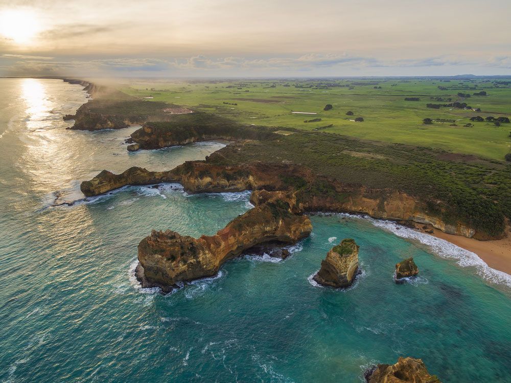 An Aerial View Of A Cliff Overlooking The Ocean And A Beach — CAL AUTO Mobile Roadworthys in Childers, QLD