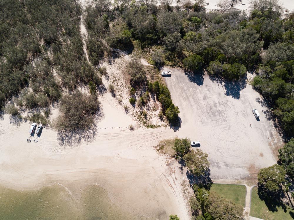 An Aerial View Of A Parking Lot Next To A Beach — CAL AUTO Mobile Roadworthys in Woodgate, QLD