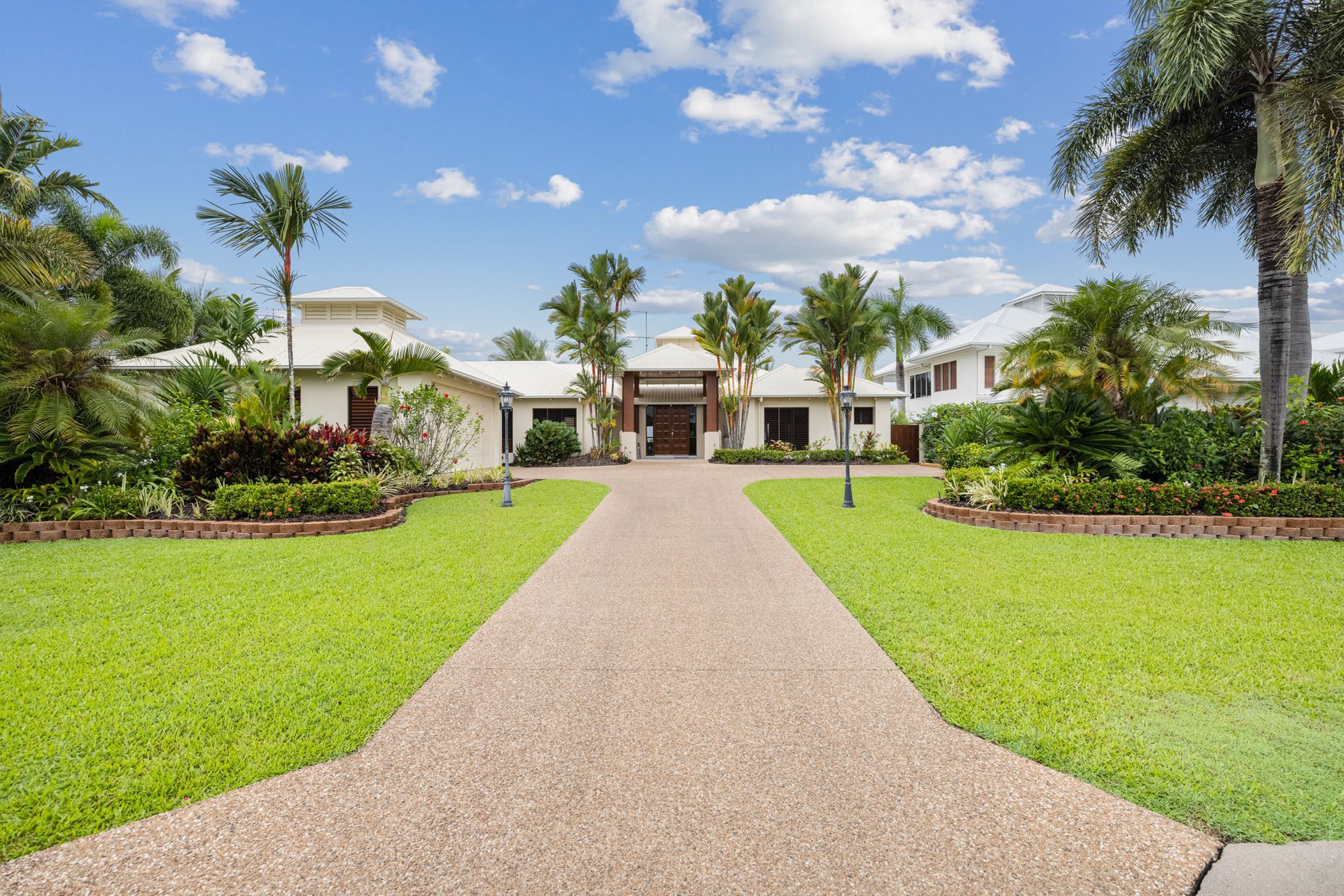 A Large White House With a Driveway Leading to It — MDSR Group in Manunda, QLD
