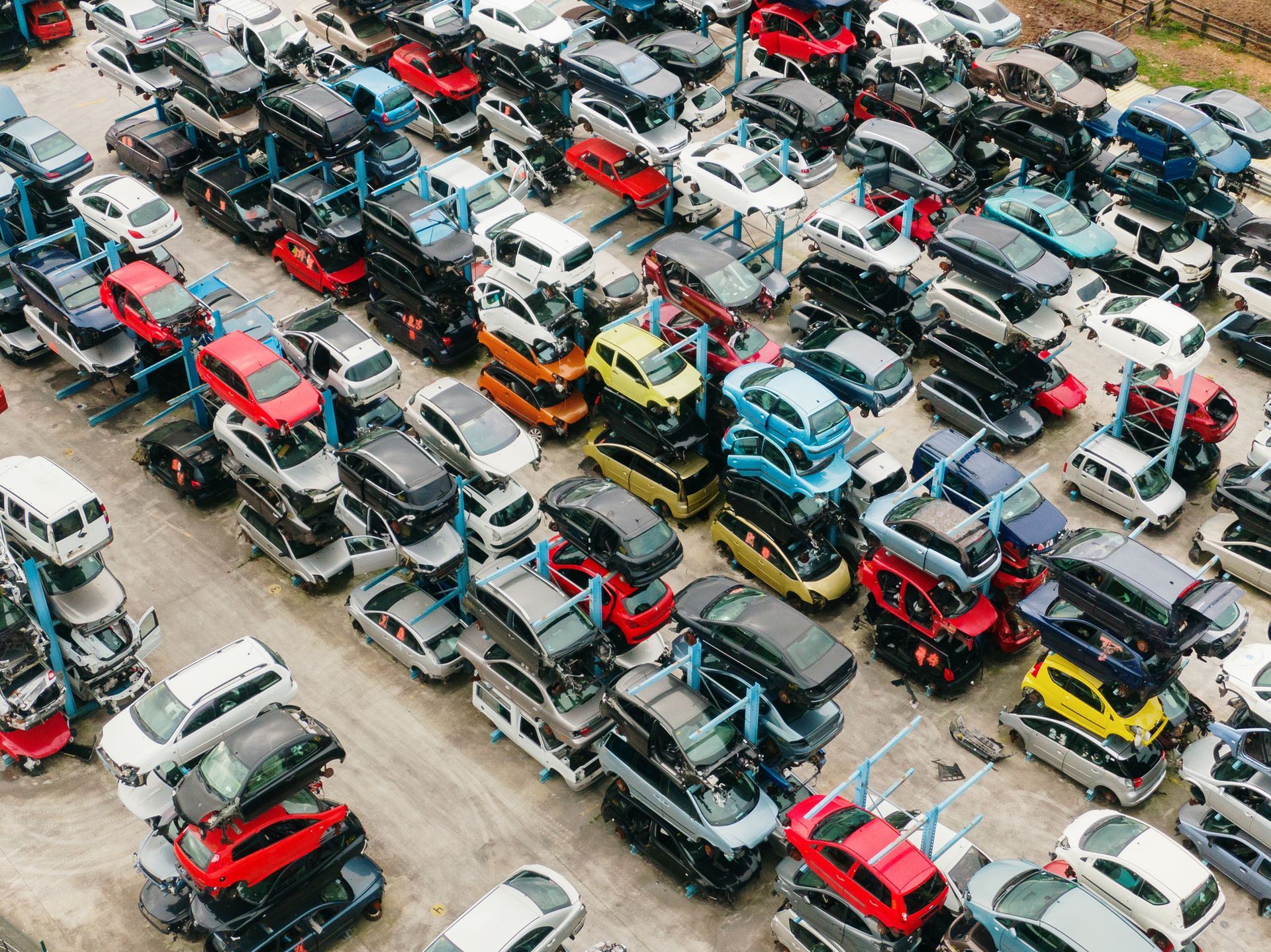 Pile of used car axles, covered in grease.