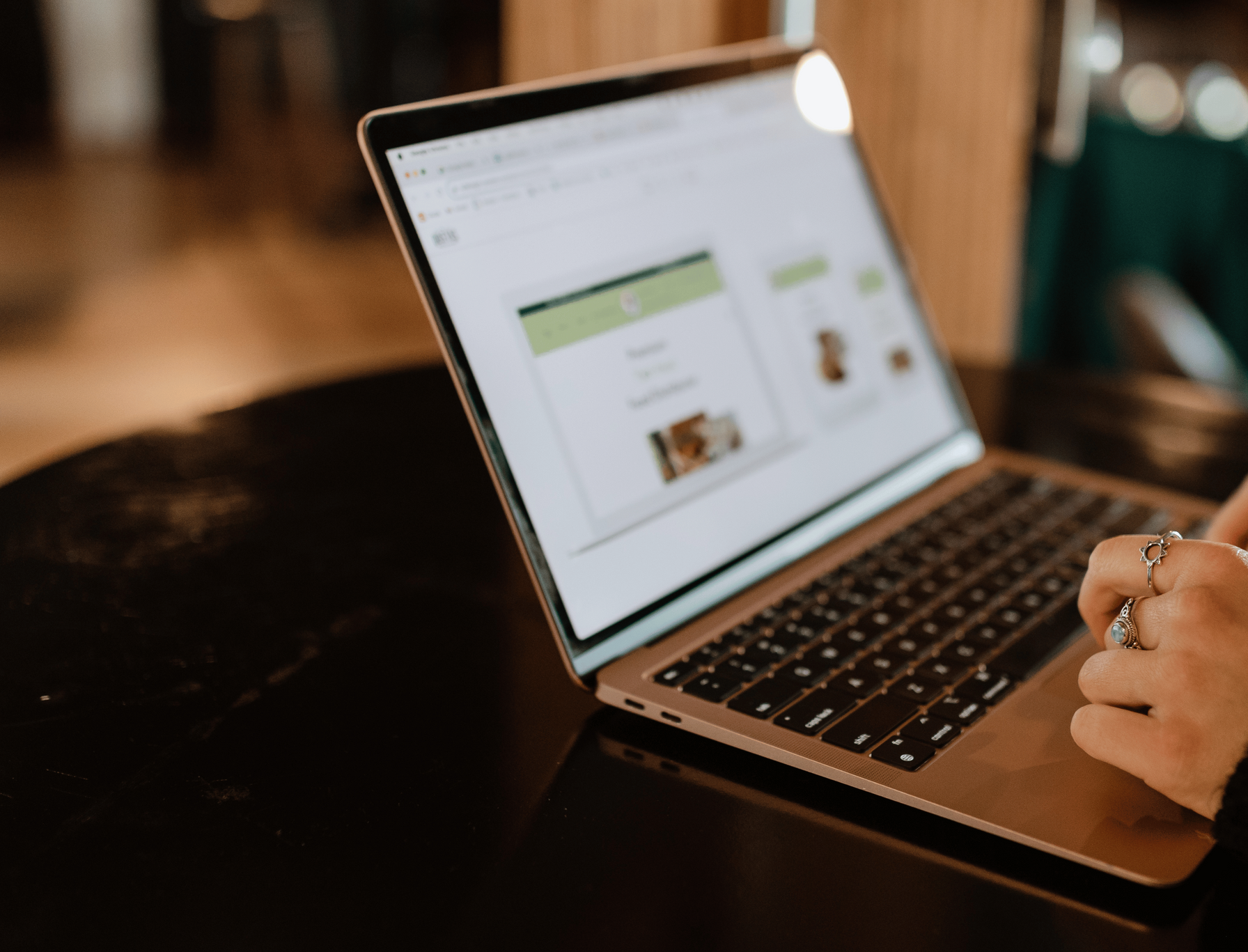 A person is using a laptop computer on a table.