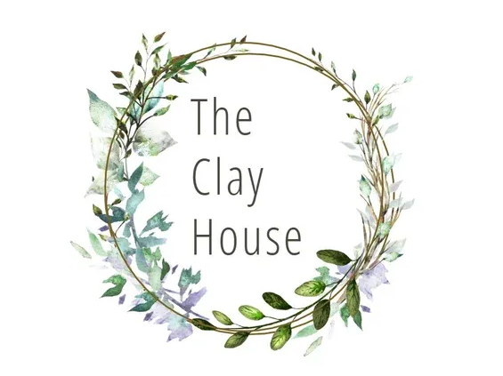 The logo for the clay house is a wreath of flowers and leaves.