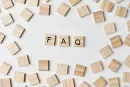 Wooden Scrabble tiles on a white background, spelling