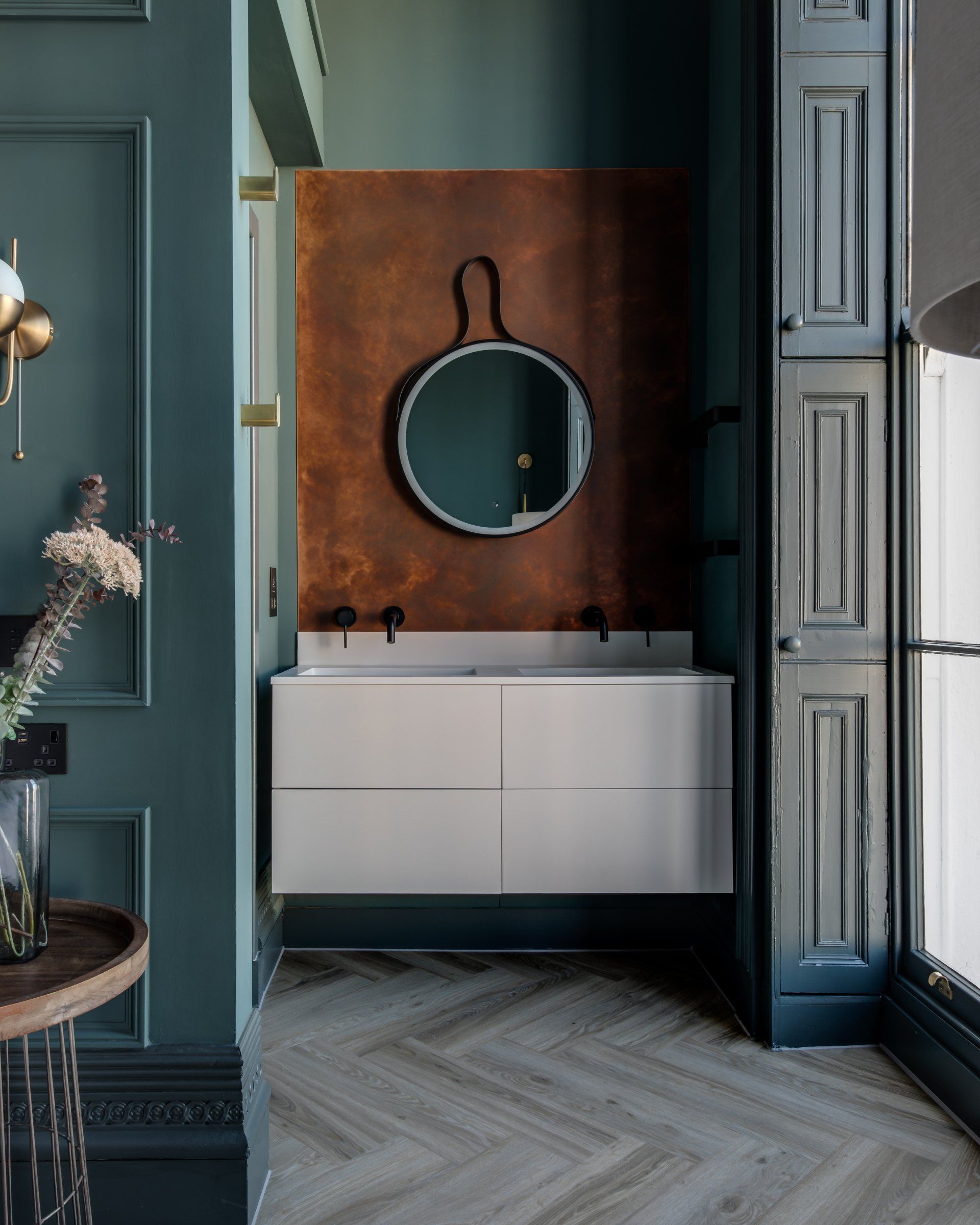 A bathroom with a sink and a mirror on the wall