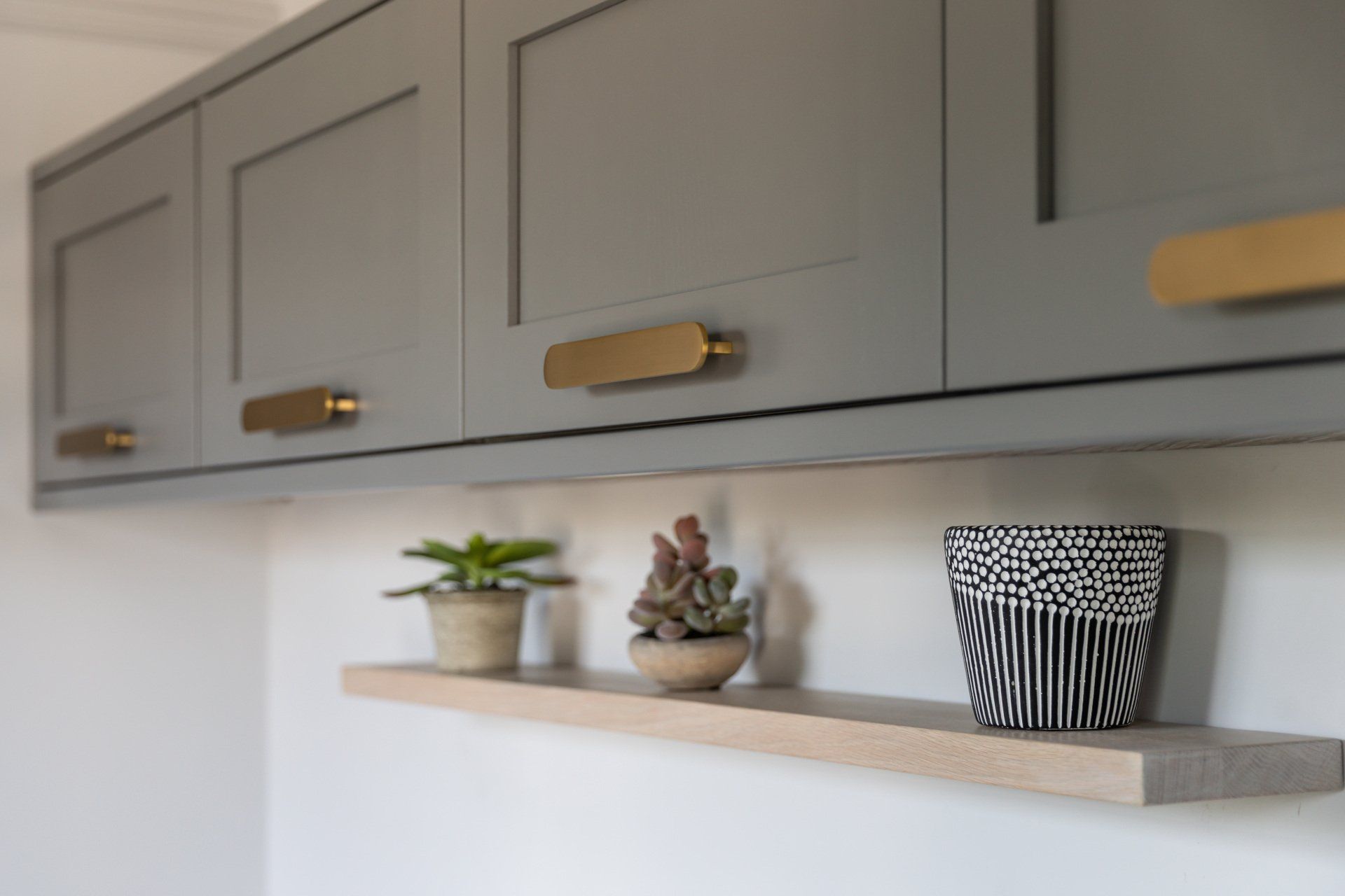 A bathroom with marble walls , a sink , a toilet and a walk in shower.