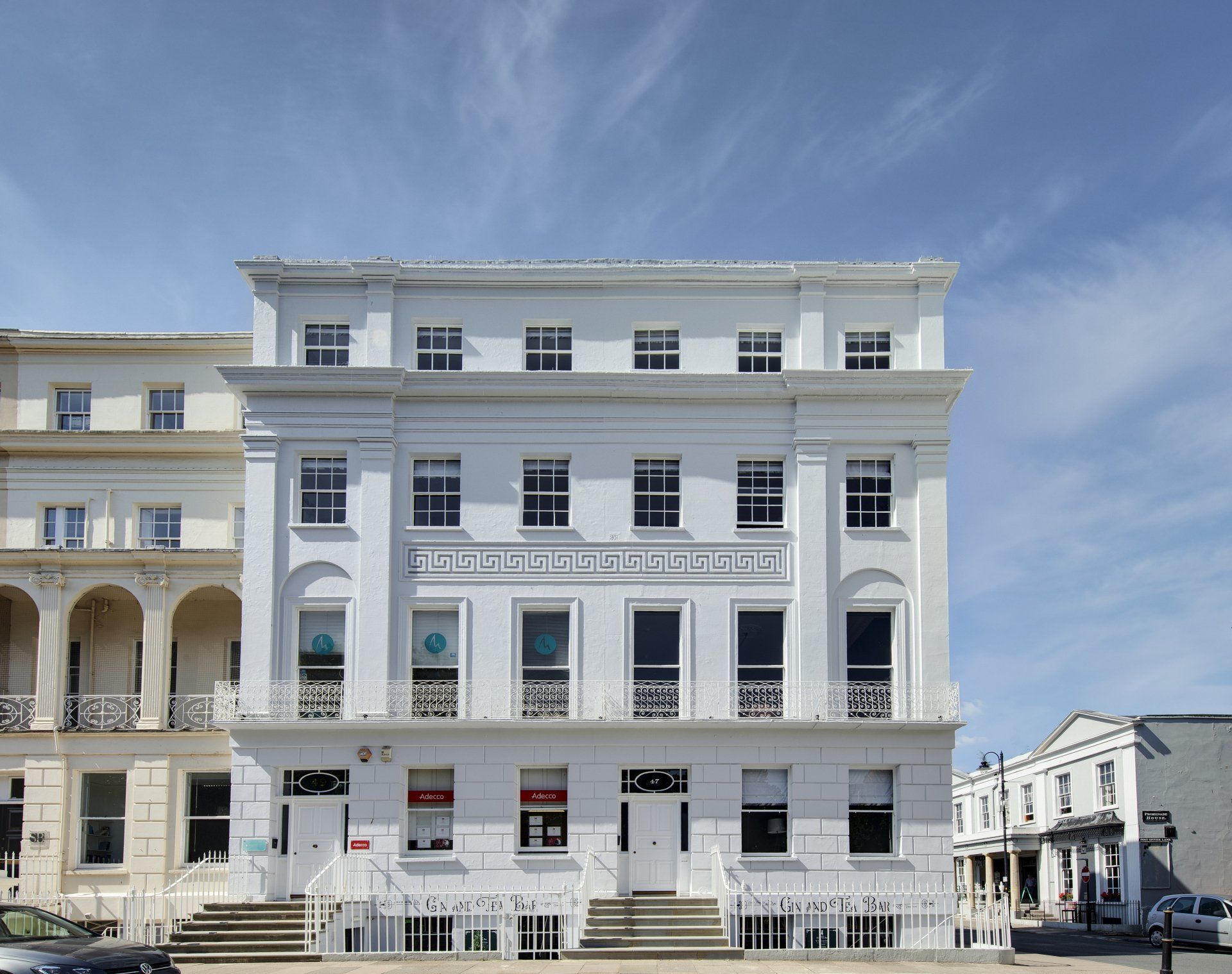 A large white building with stairs leading up to it